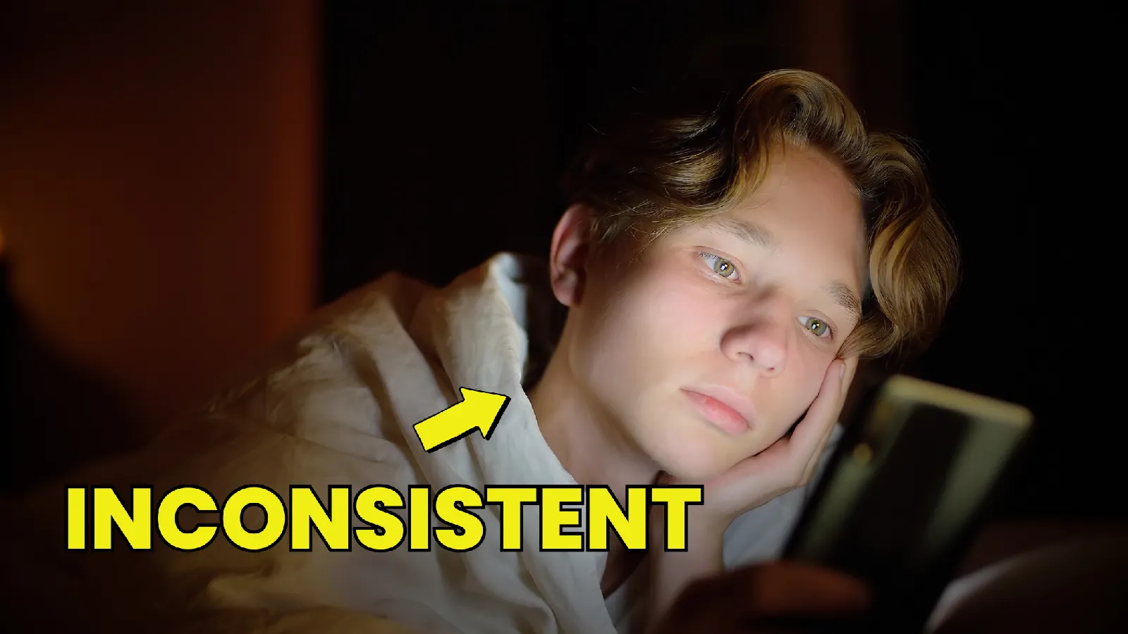 teenage-boy-looking-at-her-phone-in-bed